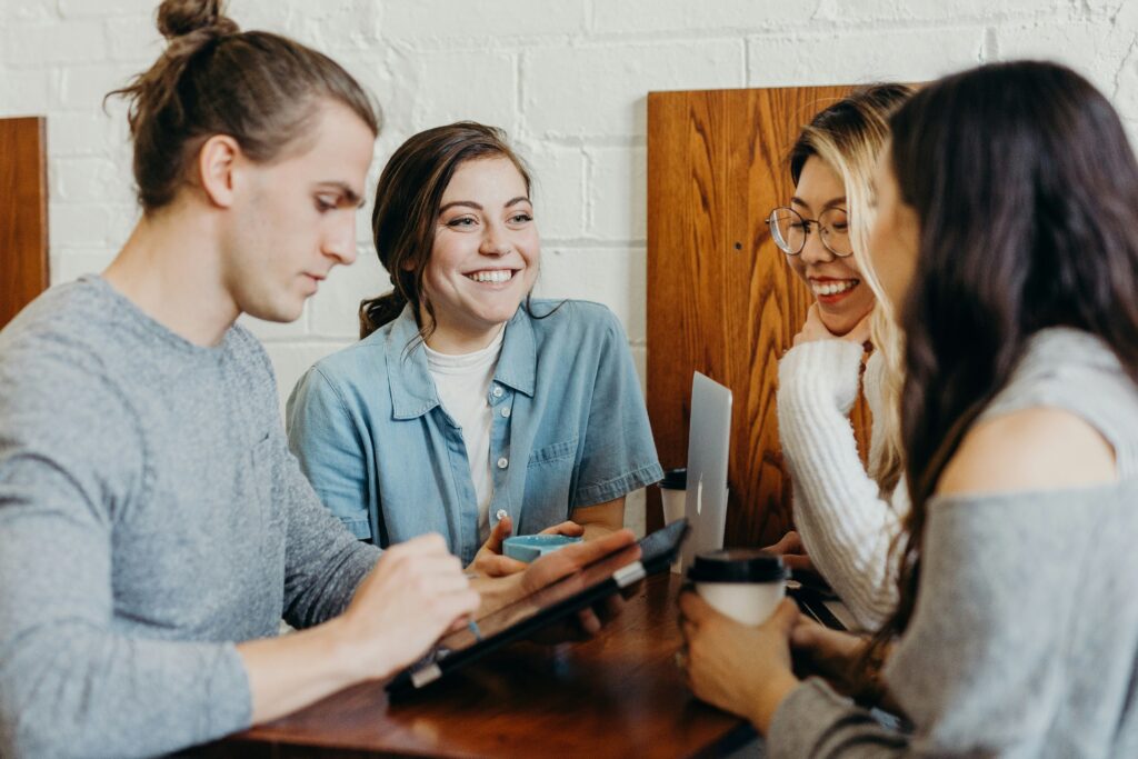 People discussing plans around a table