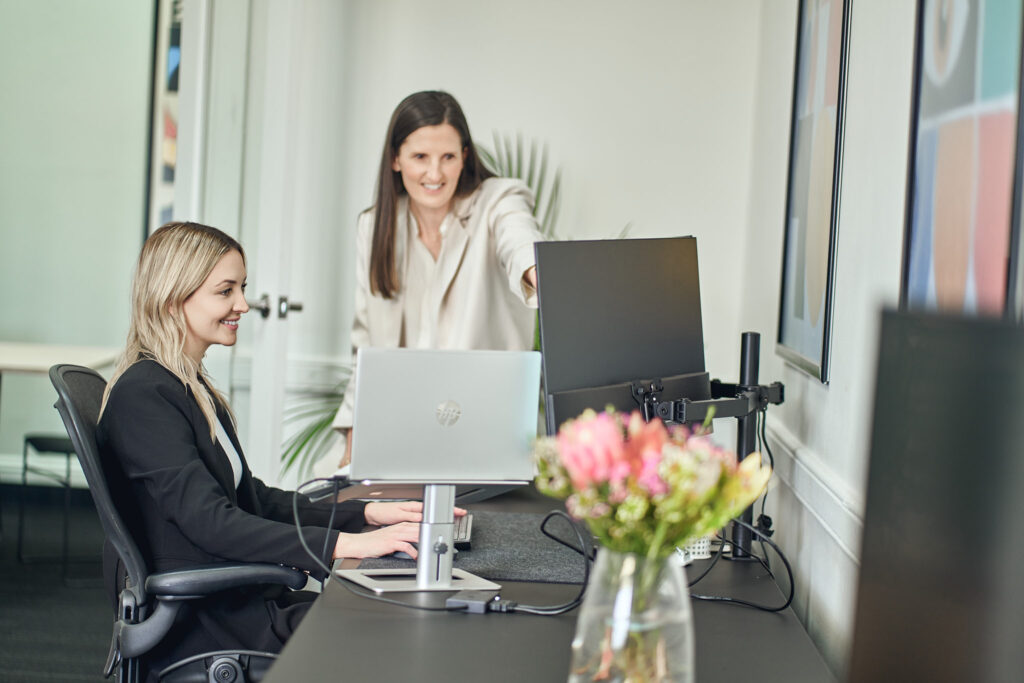 Cornerstone Consulting Group team members working together at a desk