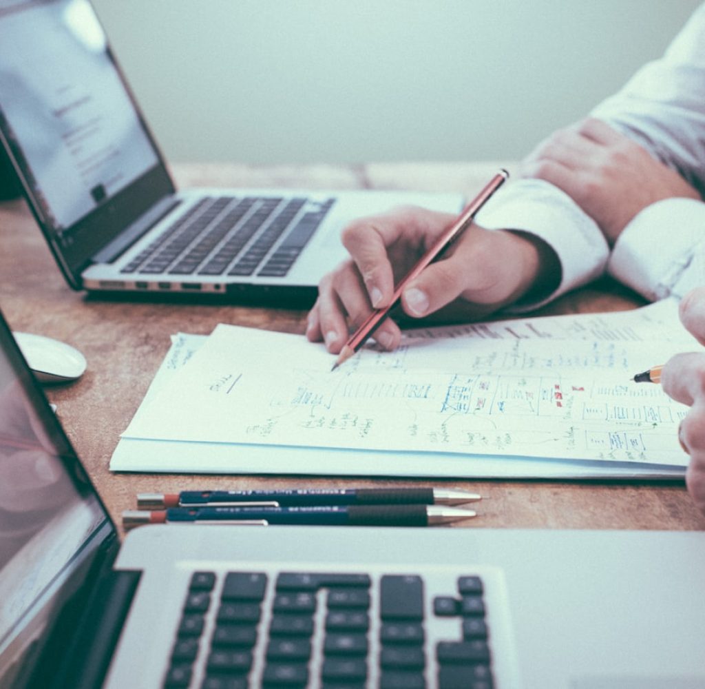 HR consultant in Adelaide reviewing plans and documents with a client at a desk